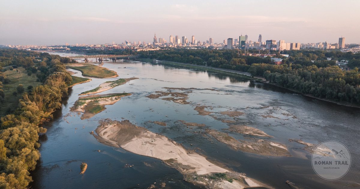Aerial view of the Vistula river winding through the Warsaw skyline at sunset, Poland