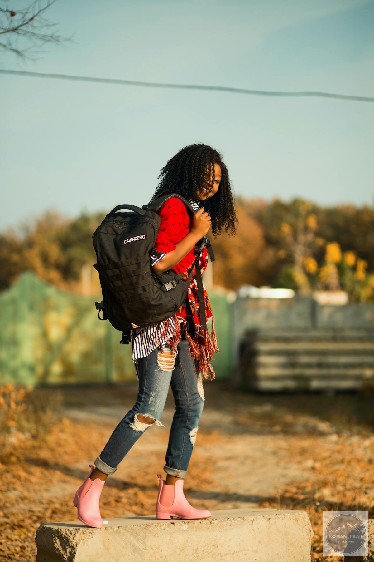 Woman with hiking backpack and outdoor layers for Scotland travel