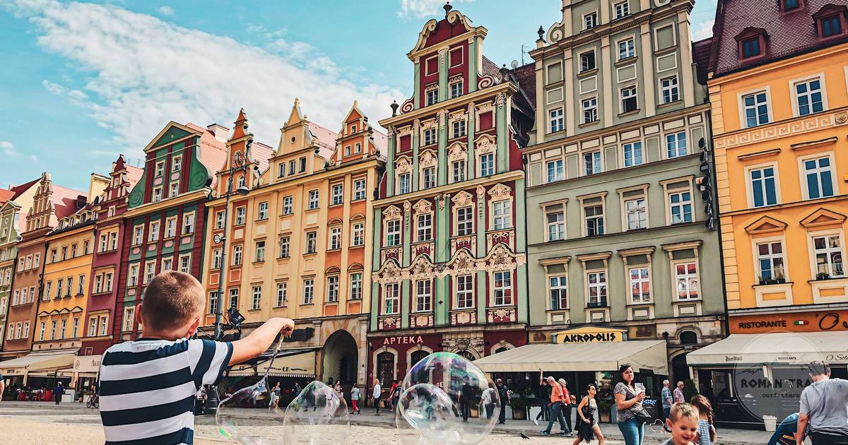 Children playing in the historic market square at Wroclaw, Poland