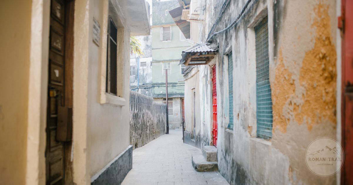 A narrow paved street between old stone houses in Stone Town, Zanzibar